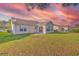 Spacious backyard featuring a sunroom and a well-maintained lawn, perfect for outdoor enjoyment at 4524 E Walkerton Rd., Myrtle Beach, SC 29579