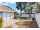 Spacious backyard with concrete patio, lush landscaping, and privacy fence at 4703 Bermuda Way, Myrtle Beach, SC 29577