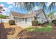 Home's backyard featuring patio, manicured lawn, and privacy landscaping at 4703 Bermuda Way, Myrtle Beach, SC 29577