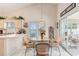 Cozy dining area featuring a glass table, wicker chairs, and access to an enclosed patio at 4703 Bermuda Way, Myrtle Beach, SC 29577