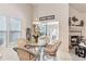 Bright dining area with wicker chairs, a glass table, and views through sliding doors to the enclosed patio at 4703 Bermuda Way, Myrtle Beach, SC 29577