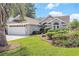 Charming home featuring a well-manicured lawn, beautiful landscaping, and an attached two-car garage at 4703 Bermuda Way, Myrtle Beach, SC 29577