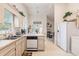 Functional kitchen with a view into the living area and abundant natural light from the window at 4703 Bermuda Way, Myrtle Beach, SC 29577