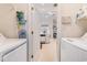 Laundry room with appliances, storage, and a view of adjacent living spaces at 4703 Bermuda Way, Myrtle Beach, SC 29577