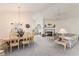 Open-concept living space features neutral carpeting, fireplace, and abundant natural light at 4703 Bermuda Way, Myrtle Beach, SC 29577