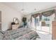 Light-filled main bedroom with ceiling fan, patio access, and neutral decor at 4703 Bermuda Way, Myrtle Beach, SC 29577