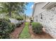 Well-maintained side yard with manicured landscaping and a charming walkway at 4703 Bermuda Way, Myrtle Beach, SC 29577