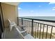 Enjoy ocean views from the balcony with seating and a small table at 4800 S Ocean Blvd. # 1008, North Myrtle Beach, SC 29582