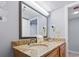 Clean bathroom featuring double sinks, granite countertops, and a large mirror at 4800 S Ocean Blvd. # 1008, North Myrtle Beach, SC 29582