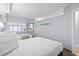 Well-lit bedroom featuring two queen beds, white walls, and shuttered windows at 4800 S Ocean Blvd. # 1008, North Myrtle Beach, SC 29582