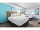 Comfortable bedroom featuring two queen beds, stylish decor, and beach-themed accents at 4800 S Ocean Blvd. # 1008, North Myrtle Beach, SC 29582
