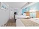 Bright bedroom featuring two beds, an open doorway, a closet, and a TV at 4800 S Ocean Blvd. # 1008, North Myrtle Beach, SC 29582