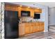 Practical kitchenette featuring wooden cabinetry, granite countertops, and essential appliances at 4800 S Ocean Blvd. # 1008, North Myrtle Beach, SC 29582