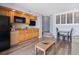Compact kitchenette with wooden cabinets and a cozy dining area at 4800 S Ocean Blvd. # 1008, North Myrtle Beach, SC 29582