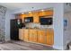 Well-equipped kitchenette featuring wood cabinets, granite countertops, and modern appliances at 4800 S Ocean Blvd. # 1008, North Myrtle Beach, SC 29582