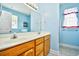 Bright bathroom with blue walls featuring double vanity, cabinet storage, and tiled flooring at 501 Painted Duck Ct., Myrtle Beach, SC 29588