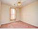 A standard bedroom contains a ceiling fan and a window with light-brown curtains at 501 Painted Duck Ct., Myrtle Beach, SC 29588
