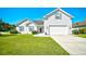 Charming two-story home with white siding, well-manicured lawn, and attached two-car garage at 501 Painted Duck Ct., Myrtle Beach, SC 29588
