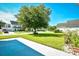 Home's front yard has green grass and a tree in the center with surrounding neighborhood at 501 Painted Duck Ct., Myrtle Beach, SC 29588