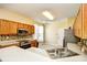 Well-lit kitchen boasts stainless steel appliances, wood cabinets, and solid surface countertops at 501 Painted Duck Ct., Myrtle Beach, SC 29588