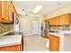 Well-lit kitchen boasts stainless steel appliances and plenty of wood cabinet storage at 501 Painted Duck Ct., Myrtle Beach, SC 29588