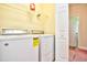 Well-lit laundry room includes a washer and dryer and built in shelving for organization at 501 Painted Duck Ct., Myrtle Beach, SC 29588