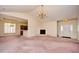 Open living room with fireplace, chandelier, and view into the kitchen and entryway at 501 Painted Duck Ct., Myrtle Beach, SC 29588