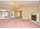 Open living room with large windows, a fireplace, and views into other areas of the home at 501 Painted Duck Ct., Myrtle Beach, SC 29588