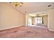 Open living room with sliding glass doors to the outside and large windows bringing in natural light at 501 Painted Duck Ct., Myrtle Beach, SC 29588