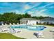 Community pool features plenty of lounge chairs and a relaxing atmosphere with trees in the background at 501 Painted Duck Ct., Myrtle Beach, SC 29588