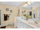 Bright bathroom featuring a double sink vanity, ample storage, and decorative accents at 509 June Bug Ct., Myrtle Beach, SC 29588