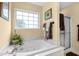 Relaxing bathroom with a jacuzzi tub beneath a window, with a shower to the side at 509 June Bug Ct., Myrtle Beach, SC 29588
