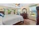 Relaxing bedroom featuring hardwood floors, with a view of nature from large windows at 509 June Bug Ct., Myrtle Beach, SC 29588