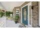 Welcoming front porch with a decorative front door, white railing, and outdoor seating at 509 June Bug Ct., Myrtle Beach, SC 29588
