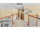 Upstairs hallway featuring wood railings, neutral carpet, and bright walls at 509 June Bug Ct., Myrtle Beach, SC 29588