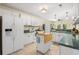 Well-lit kitchen boasting white cabinets, green countertops, a mobile island, and modern appliances at 509 June Bug Ct., Myrtle Beach, SC 29588