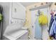 Efficient laundry room features a stacked washer and dryer unit, sink, and storage shelves at 509 June Bug Ct., Myrtle Beach, SC 29588