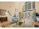 Bright and open living room with large windows, comfortable seating, and stylish decor at 509 June Bug Ct., Myrtle Beach, SC 29588