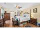 Comfortable main bedroom featuring hardwood floors, a four-poster bed, and generous closet space at 509 June Bug Ct., Myrtle Beach, SC 29588