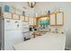 Bright kitchen boasting white appliances, ample cabinet space, and a charming coastal aesthetic at 510 Fairwood Lakes Dr. # R-17, Myrtle Beach, SC 29588