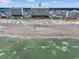 Aerial view of beachfront condos, sandy beach, and ocean waves under a blue sky at 5404 N Ocean Blvd. # 11-D, North Myrtle Beach, SC 29582