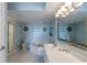 Bright bathroom features double vanity, bathtub, and tiled shower with glass door at 5404 N Ocean Blvd. # 11-D, North Myrtle Beach, SC 29582