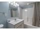 Bathroom with shower and tub combination plus single vanity with white cabinets at 5404 N Ocean Blvd. # 11-D, North Myrtle Beach, SC 29582
