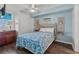 Bedroom with ceiling fan, queen bed and wood-look floors at 5404 N Ocean Blvd. # 11-D, North Myrtle Beach, SC 29582