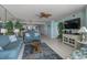 Bright living room with an open floor plan, tile floors, and a full mirrored wall at 5404 N Ocean Blvd. # 11-D, North Myrtle Beach, SC 29582