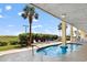Community pool and lounge chairs, surrounded by vegetation, and palm trees at 5404 N Ocean Blvd. # 11-D, North Myrtle Beach, SC 29582