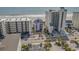 An aerial view captures buildings with beach access and pool view surrounded by palm trees at 5801 Oyster Catcher Dr. # 832, North Myrtle Beach, SC 29582