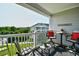 Inviting balcony space with seating and a view of the well-manicured lawn at 5801 Oyster Catcher Dr. # 832, North Myrtle Beach, SC 29582