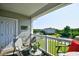 Comfortable outdoor seating area on a covered balcony, offering serene views of the lush surroundings at 5801 Oyster Catcher Dr. # 832, North Myrtle Beach, SC 29582