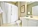 Simple bathroom featuring a shower with white curtain, toilet, and vanity with sink at 5801 Oyster Catcher Dr. # 832, North Myrtle Beach, SC 29582